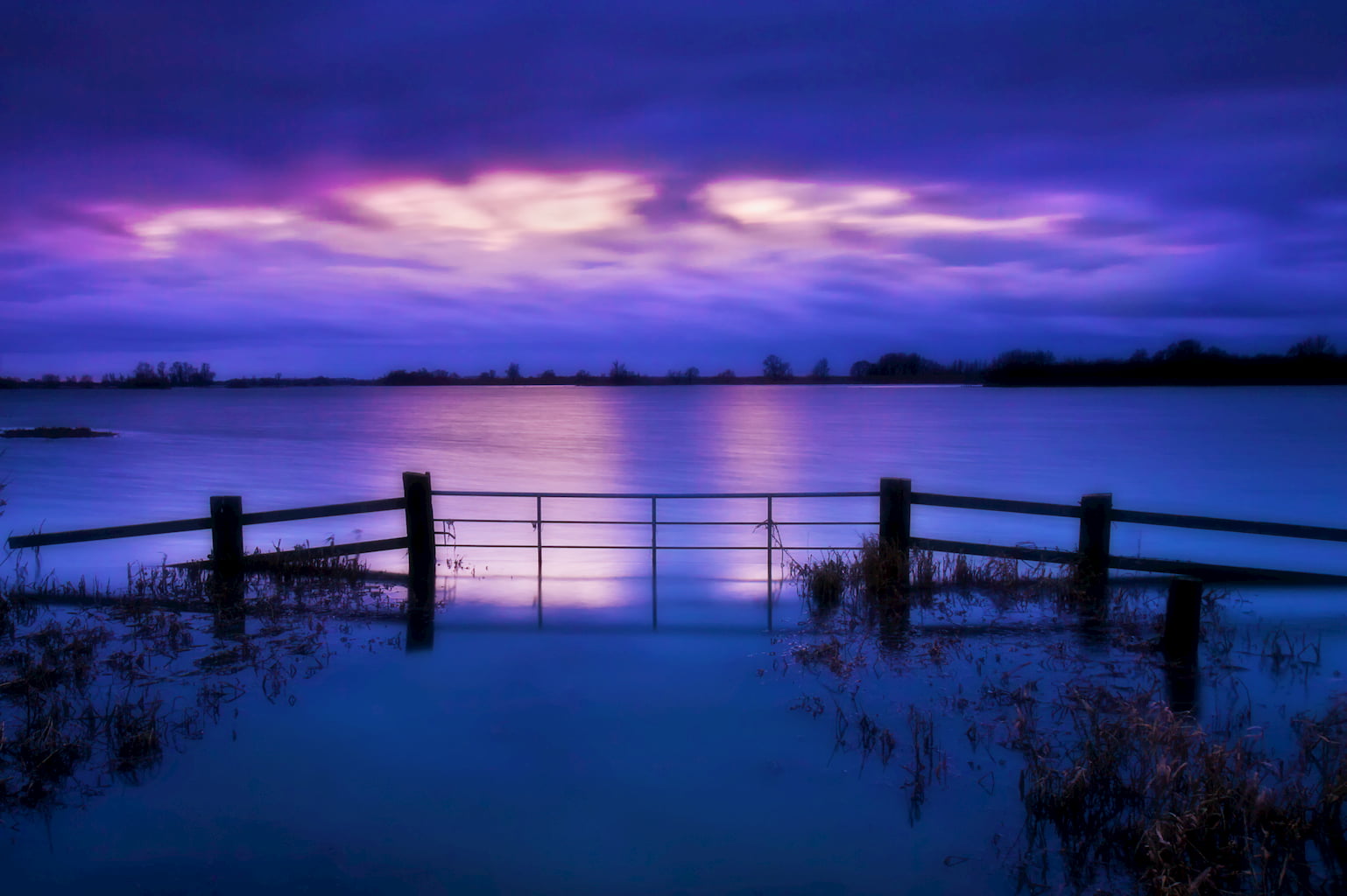 A stormy sky over the flooded  Hundred Foot Ouse Washes at Sutton Gault, Cambs.