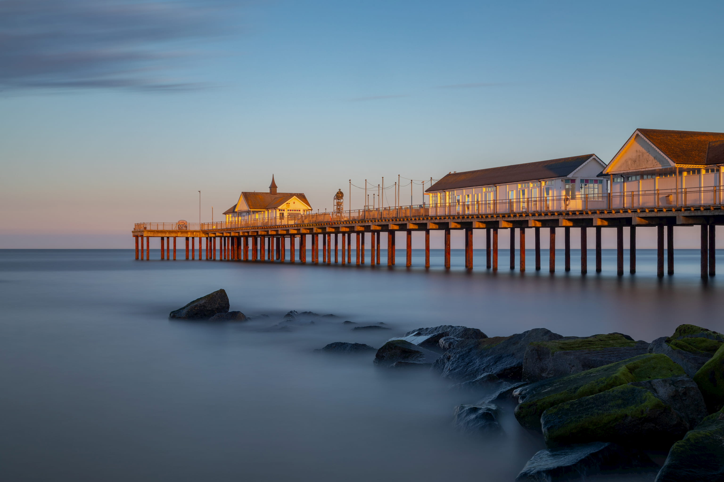 Long exposure photograph of Southwold Pier in Suffolk at dusk just after sunset. 